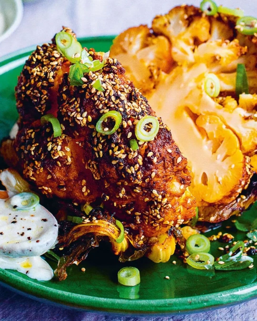 Whole roasted cauliflower with creamy sauce